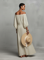 Vestido largo de lino con hombros descubiertos, bordado y mangas abullonadas.