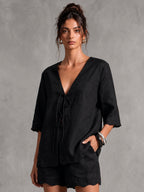 Leinen-V-Ausschnitt-Bluse mit Bindedetail und 3/4-Ärmeln sowie Wellensaum