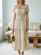 Vestido largo escalonado con volantes y hombros descubiertos