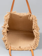 Borsa tote in rafia intrecciata a mano con frange.